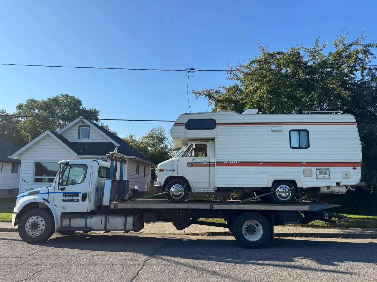 Total Towing flatbed tow truck carrying a motorhome in Thunder Bay