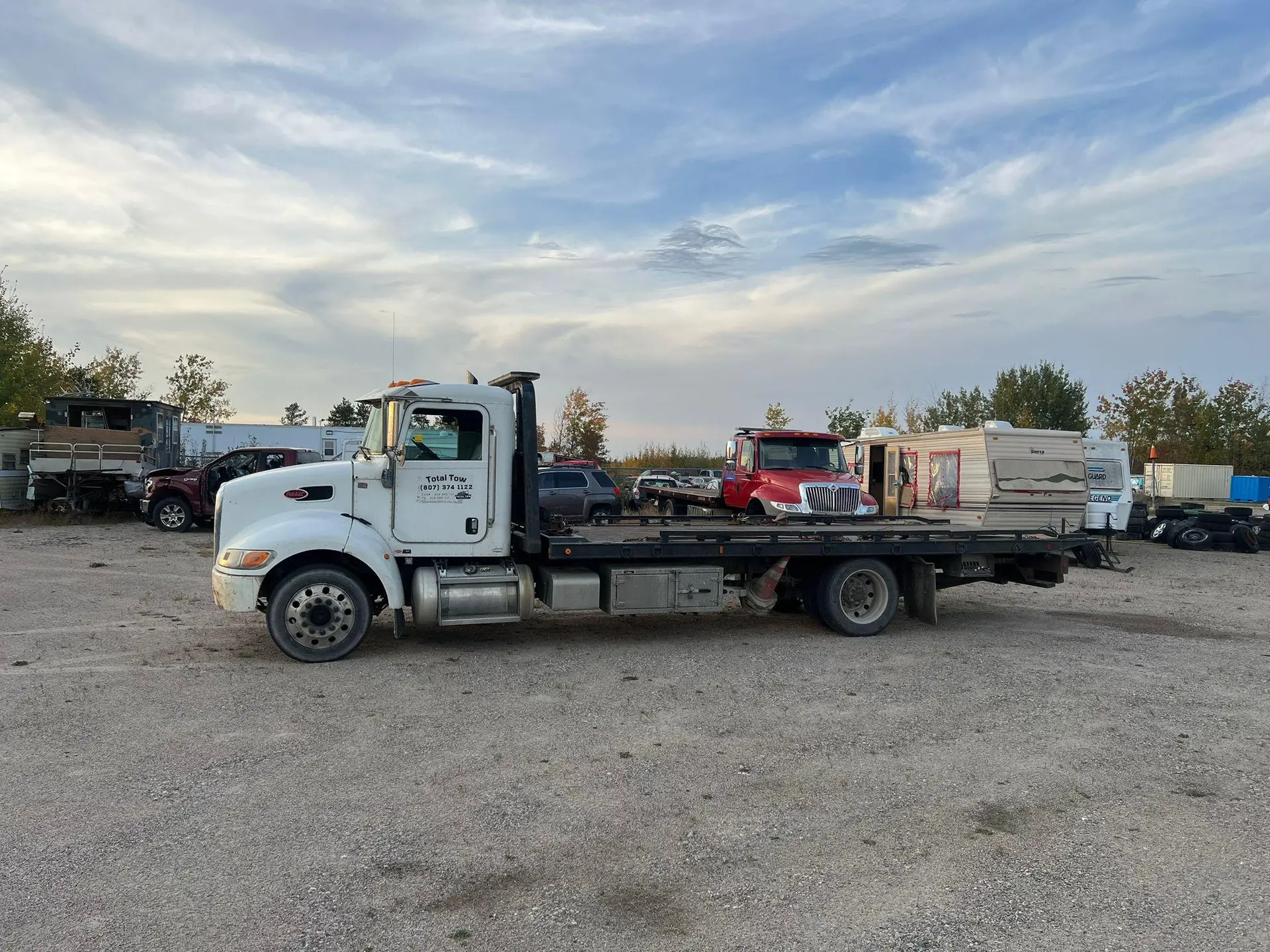 Total Towing flatbed truck in the company yard in Thunder Bay